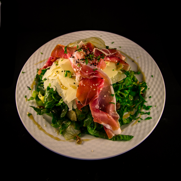 Salad with parmesan cheese and prosciutto